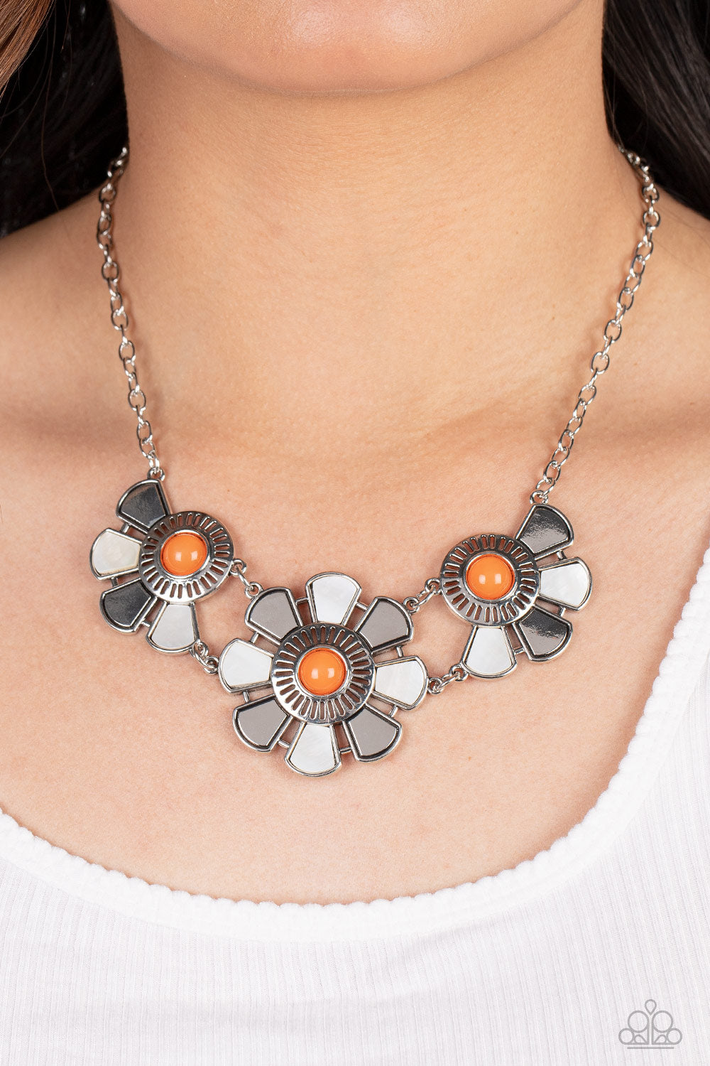 Aquatic Garden Orange Necklace - Paparazzi Accessories Item #P2ST-OGXX-106XX Dotted with orange bead centers, silver and white shell-like petals fan out from an airy metal frame. The trio of whimsically industrial flowers connects to a conventional silver chain below the collar resulting in an unabashedly metropolitan display. Features an adjustable clasp closure.  Sold as one individual necklace. Includes one pair of matching earrings.