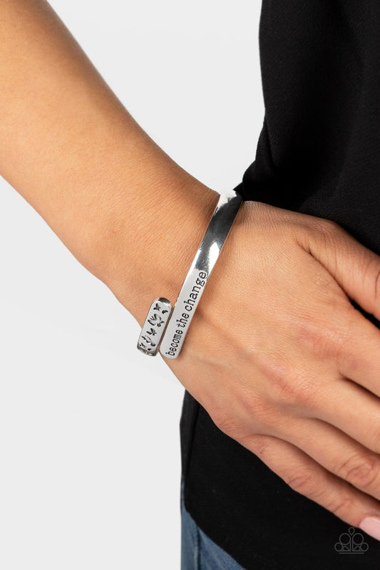 WINGS of Change Silver Bracelet - Paparazzi Accessories  Shiny silver bars curve and overlap around the wrist, creating a stacked design. One silver bar is stamped with the phrase, "become the change," while the other features engraved butterfly silhouettes in an inspiring finish. Features a hinged closure.  Sold as one individual bracelet.