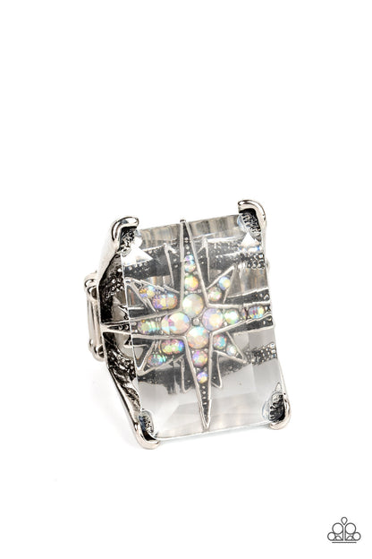 Starry Serenity Multi Ring - Paparazzi Accessories  A white iridescent rhinestone-dotted star twinkles behind a glassy pane that seemingly floats atop the pronged frame, resulting in a stellar statement piece. Due to its prismatic palette, color may vary. Features a stretchy band for a flexible fit.  Sold as one individual ring.