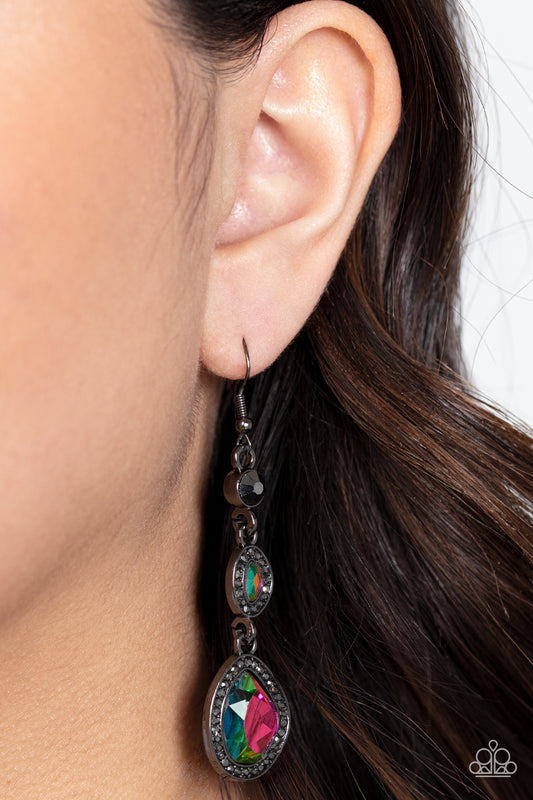 Dripping Self-Confidence Multi Oil Spill Earring - Paparazzi Accessories  Bordered in gunmetal frames dotted with tiny flecks of hematite rhinestones, a pair of asymmetrical gems with an oil-spill finish delicately link into a spellbinding sparkle around the ear. Earring attaches to a standard fishhook fitting.  Sold as one pair of earrings.