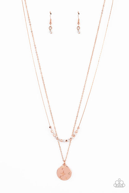 Stunning Supernova Copper Necklace - Paparazzi Accessories  Dotted with a single shiny copper stud, a star-stamped shiny copper disc glistens at the bottom of a classic shiny copper chain. Infused with faceted copper beads, a stellar collection of clear crystal-like beads glides along a flat copper chain, resulting in out-of-this-world layers below the collar. Features an adjustable clasp closure.  Sold as one individual necklace. Includes one pair of matching earrings.
