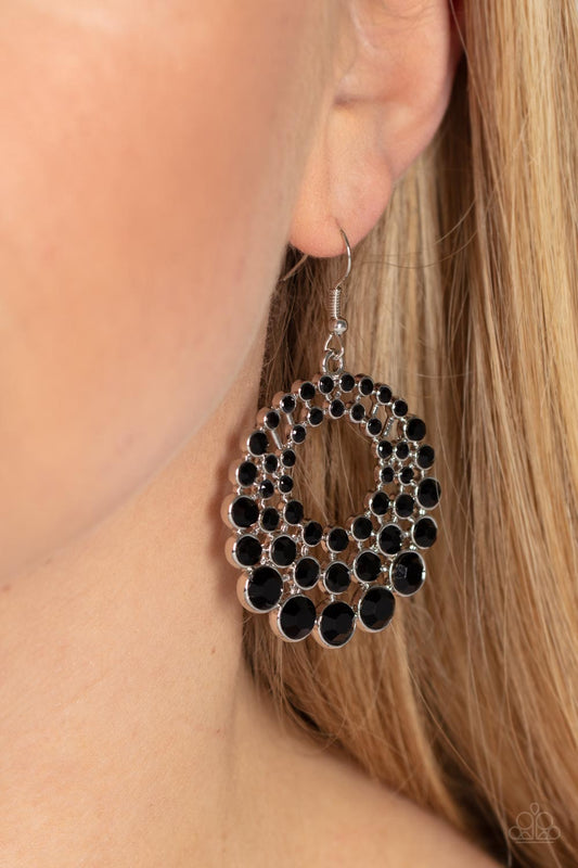 So Self-GLOW-rious Black Earring - Paparazzi Accessories  Gradually increasing in size and intensity, row after row of glassy jet black rhinestones stack into a layered hoop for a blinding effervescence. Earring attaches to a standard fishhook fitting.  Sold as one pair of earrings.