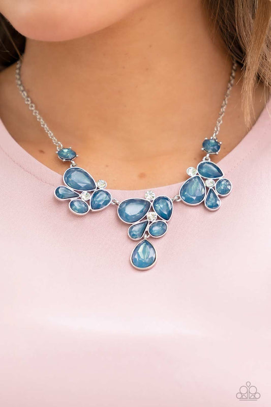 Everglade Escape Blue Necklace - Paparazzi Accessories  Draped elegantly across the chest, clusters of geometric blue gems, brushed in the fall Pantone® of Midnight, gather around sparkling white rhinestones, creating a bright and beautiful pattern. Features an adjustable clasp closure.  Sold as one individual necklace. Includes one pair of matching earrings.