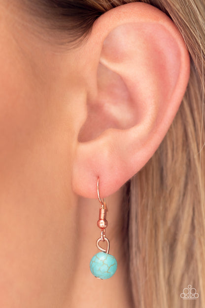 Sahara Sea Copper Necklace - Paparazzi Accessories  Dangling from a shiny copper chain, an asymmetrical white shell with an opal finish is encircled by a turquoise stone-studded frame, creating a seasonal Southwestern pattern. As the stone elements in this piece are natural, some color variation is normal. Features an adjustable clasp closure.  Sold as one individual necklace. Includes one pair of matching earrings.