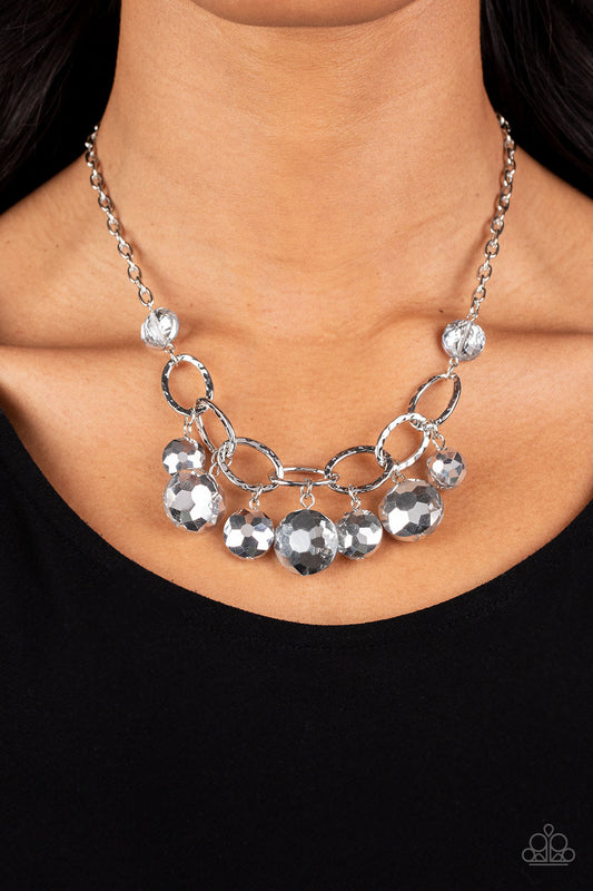Rhinestone River Silver Necklace - Paparazzi Accessories  A collection of round, glassy silver beads in varying sizes swirl around shiny silver oval links hammered in texture. The beveled shape and faceted surfaces of the beads are brushed in a subtle reflective glaze, creating a dreamy display as they drip below the collar. Features an adjustable clasp closure.  Sold as one individual necklace. Includes one pair of matching earrings.