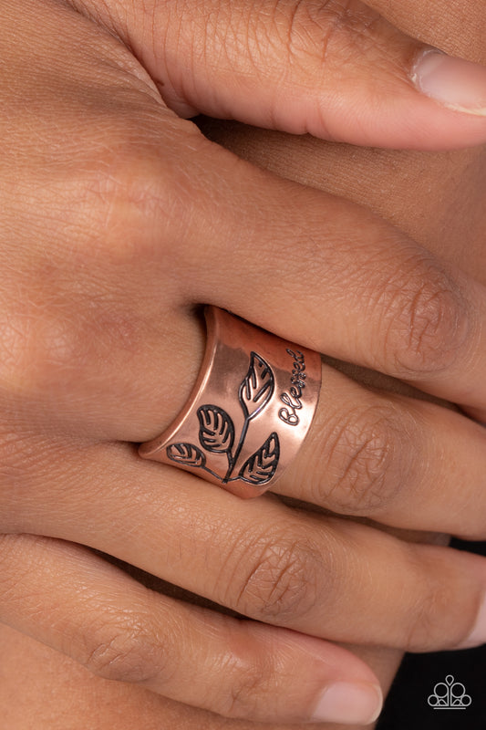 Blessed with Bling Copper Ring - Paparazzi Accessories  A thick band of copper is etched with a dainty leaf motif as the edges flare slightly to create a subtle curve. The word "blessed" is stamped at the bottom in an inspirational finish. Features a stretchy band for a flexible fit.  Sold as one individual ring.