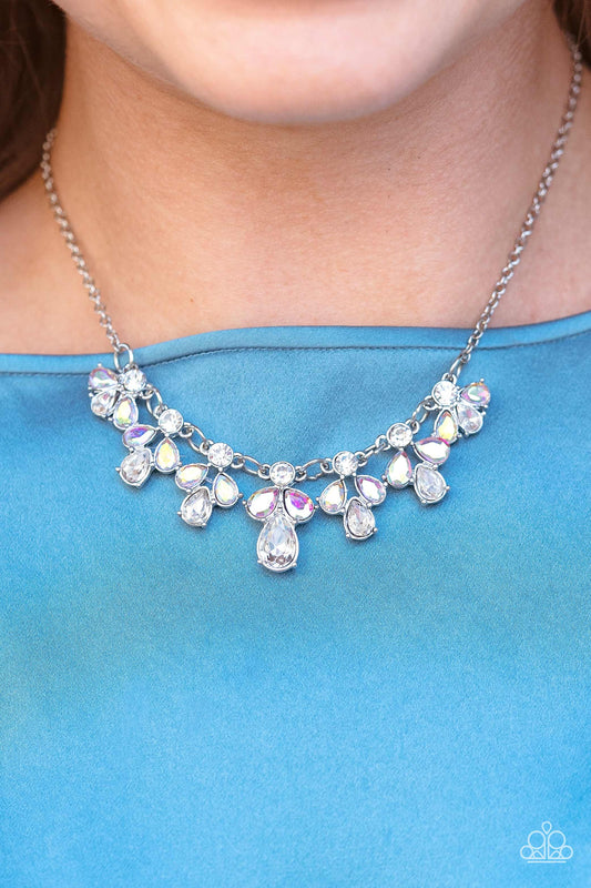 See in a New STARLIGHT White Necklace - Paparazzi Accessories  Dainty white reflective gems, followed by a trio of iridescent and reflective teardrop gems vertically blaze down the collar, creating a starry shimmer. Due to its prismatic palette, color may vary. Features an adjustable clasp closure.  Sold as one individual necklace. Includes one pair of matching earrings.