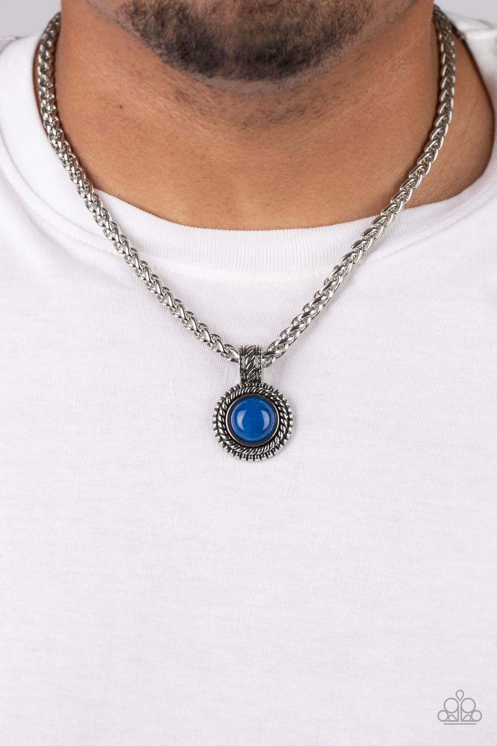 Pendant Dreams Blue Urban Necklace - Paparazzi Accessories  A textured silver frame spins around a lapis stone center, creating a tranquil statement piece. The reflective pendant is anchored by a textured silver fixture, adding eye-catching dimension as the pendant slides along a thick strand of silver wheat chain. Features an adjustable clasp closure. As the stone elements in this piece are natural, some color variation is normal.  Sold as one individual necklace.