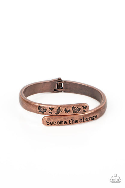 WINGS of Change Copper Hinge Bracelet - Paparazzi Accessories   Antiqued copper bars curve and overlap around the wrist, creating a stacked design. One copper bar is stamped with the phrase, "become the change," while the other features engraved butterfly silhouettes in an inspiring finish. Features a hinged closure.  Sold as one individual bracelet.