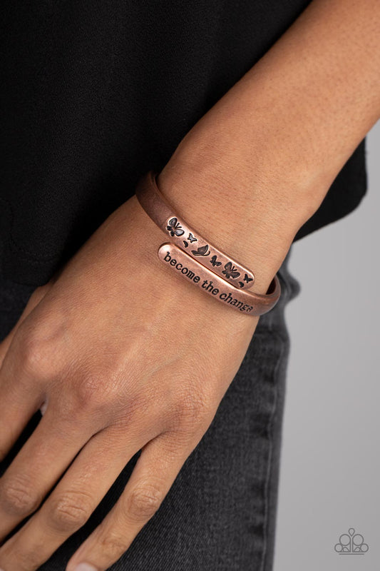 WINGS of Change Copper Hinge Bracelet - Paparazzi Accessories   Antiqued copper bars curve and overlap around the wrist, creating a stacked design. One copper bar is stamped with the phrase, "become the change," while the other features engraved butterfly silhouettes in an inspiring finish. Features a hinged closure.  Sold as one individual bracelet.