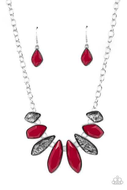 Crystallized Couture Red Necklace- Paparazzi Accessories  A thick silver chain gives way to a collection of edgy silver frames that fall in line along the collar. The asymmetrical frames are emphasized by the alternating gems inside them, resulting in a gorgeous palette of red and shimmery glitter. Features an adjustable clasp closure.  Sold as one individual necklace. Includes one pair of matching earrings.