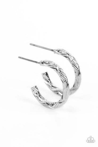 Triumphantly Textured Silver Hoop Earring - Paparazzi Accessories   A delicate band of silver is etched in linear textures, curling around the ear to create a small, classic hoop. Earring attaches to a standard post fitting. Hoop measures approximately 1/2" in diameter.  Sold as one pair of hoop earrings.