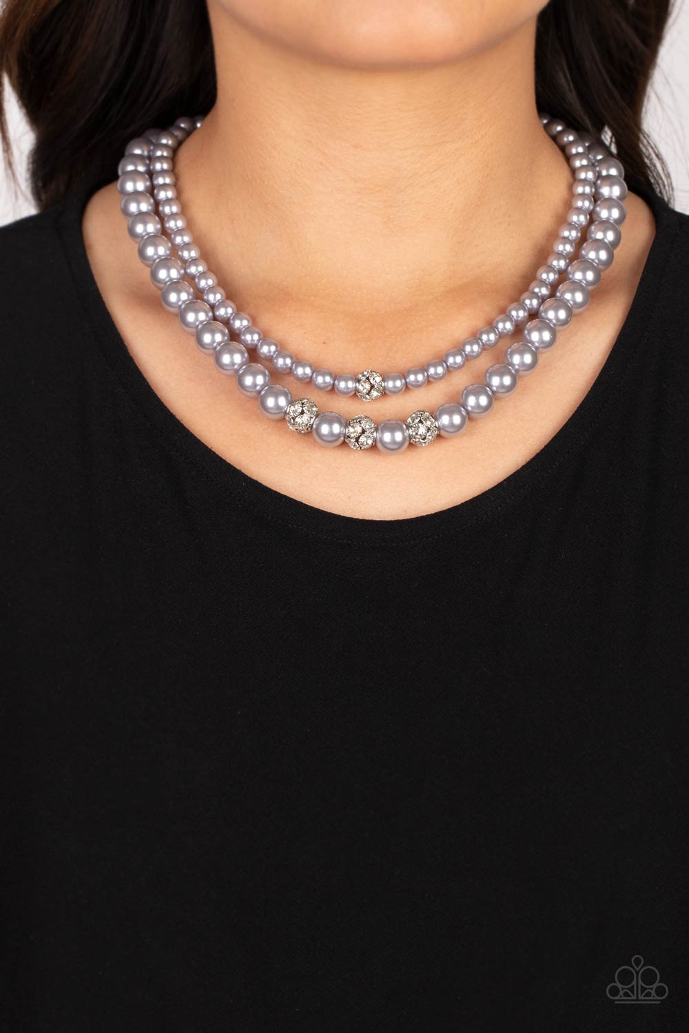 Brilliant Ballerina Silver Pearl Necklace - Paparazzi Accessories   Two strands of classic silver pearls in varying sizes coalesce around the collar in a refined fashion. Silver beads, encrusted in white rhinestones, introduce shimmery detail to each pearly layer, adding a playful spark of shimmer to the timeless design. Features an adjustable clasp closure.  Sold as one individual necklace. Includes one pair of matching earrings.