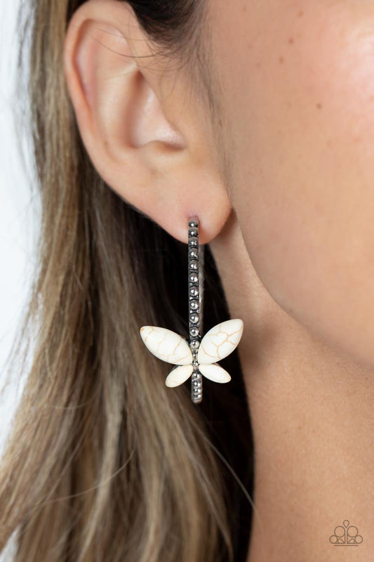 Bohemian Butterfly White Hoop Earring - Paparazzi Accessories   A dainty, white stone butterfly flutters atop the curve of a glistening silver hoop dotted with silver studs, creating a refreshing, whimsical sight. Earring attaches to a standard post fitting. Hoop measures approximately 1 1/2" in diameter. As the stone elements in this piece are natural, some color variation is normal.  Sold as one pair of hoop earrings.