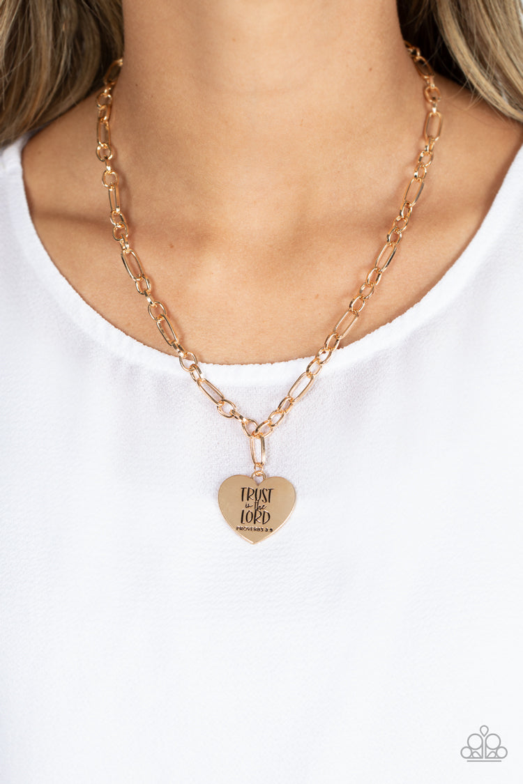 Perennial Proverbs Gold Necklace - Paparazzi Accessories  Dangling from a gold figaro chain, a charming heart pendant swings. Stamped upon the shiny surface, the phrase "Trust in the Lord" with the bible reference listed below it "Proverbs 3:5" are listed in different fonts for an optimistic and hopeful finish. Features an adjustable clasp closure.  Sold as one individual necklace. Includes one pair of matching earrings.