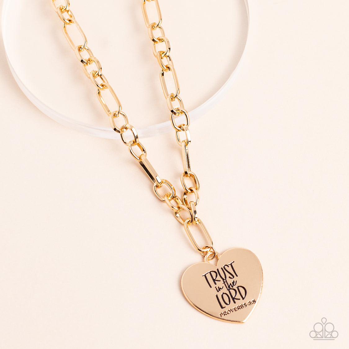 Perennial Proverbs Gold Necklace - Paparazzi Accessories  Dangling from a gold figaro chain, a charming heart pendant swings. Stamped upon the shiny surface, the phrase "Trust in the Lord" with the bible reference listed below it "Proverbs 3:5" are listed in different fonts for an optimistic and hopeful finish. Features an adjustable clasp closure.  Sold as one individual necklace. Includes one pair of matching earrings.