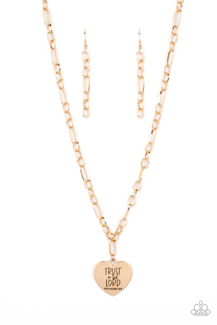 Perennial Proverbs Gold Necklace - Paparazzi Accessories  Dangling from a gold figaro chain, a charming heart pendant swings. Stamped upon the shiny surface, the phrase "Trust in the Lord" with the bible reference listed below it "Proverbs 3:5" are listed in different fonts for an optimistic and hopeful finish. Features an adjustable clasp closure.  Sold as one individual necklace. Includes one pair of matching earrings.