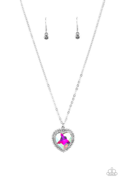 Sweethearts Stroll Multi Heart Necklace - Paparazzi Accessories   An iridescent, crystal-like heart gem sparkles dramatically as it's wrapped in a glassy white rhinestone-studded heart frame. Adding additional shimmer, a second layer of white rhinestones encircles the studded pendant as it swings from a classic silver chain in a flirty finish. Features an adjustable clasp closure. Due to its prismatic palette, color may vary.  Sold as one individual necklace. Includes one pair of matching earrings.