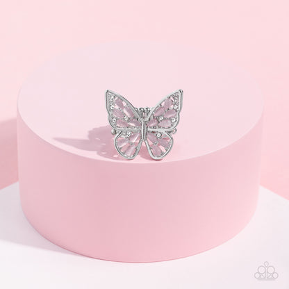 Flying Fashionista Pink Butterfly Ring - Paparazzi Accessories  Shiny silver bars curl into the shape of a butterfly, creating a whimsical centerpiece that flutters atop the finger. Pink opalescent beads fill the inside of the wings, leaving spaces in between for the design to remain airy and light. Finally, tiny white rhinestones line the inside edges of the silver frame, adding a hint of irresistible sparkle to the mix. Features a stretchy band for a flexible fit. P4WH-PKXX-248XX