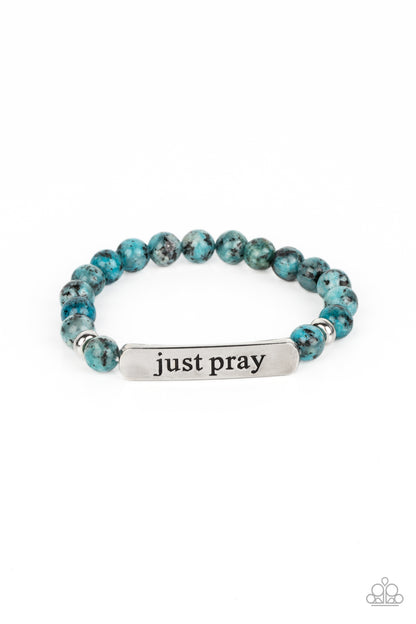 Just Pray Blue Stretch Bracelet - Paparazzi Accessories  Smooth, light blue speckled stones are stretched across the wrist on an elastic stretchy band, with accents of silver beads sprinkled in. Meeting in the center of the stony display, a curved rectangular bar is stamped with the phrase "just pray" for an inspiring finish. As the stone elements in this piece are natural, some color variation is normal.  Sold as one individual bracelet.