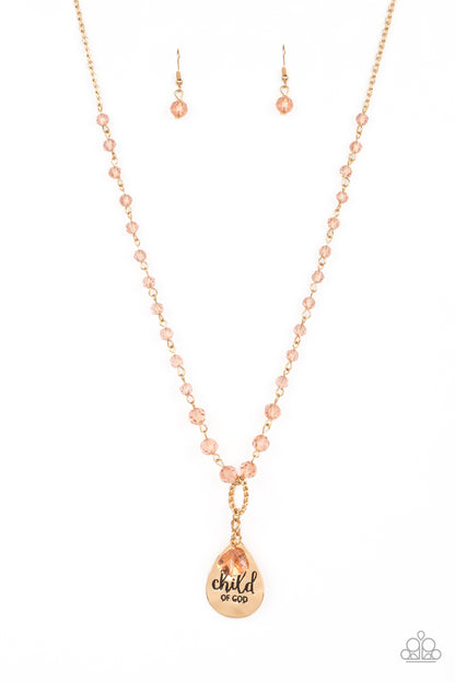 Divine Dance Gold Necklace - Paparazzi Accessories  Infused with faceted beads, featuring golden undertones, a classic gold chain holds up a textured curved gold ring. A hammered gold teardrop and glassy acrylic teardrop with golden undertones dangle below the curved ring for eye-catching movement. The phrase "child of God" is stamped across the hammered teardrop for a virtuous finish. Features an adjustable clasp closure.  Sold as one individual necklace. Includes one pair of matching earrings.