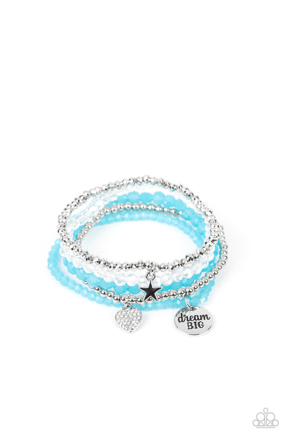 Teenage DREAMER Blue Bracelet - Paparazzi Accessories Blue, silver, white, and silver beads wrap around stretchy bands, and combine into a colorful stack along the wrist. The reflective, blue-beaded bracelet features a silver pendant with the phrase "dream BIG" stamped on it, while a defaced, silver-beaded bracelet features a silver star charm. Hanging from smooth, silver beads, a heart charm embossed with white rhinestones adds a shimmery detail to the stack, resulting in a youthful, dreamy design.