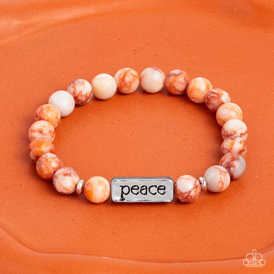 Serene Season Orange Stretch Bracelet - Paparazzi Accessories  Meeting at the center of an elastic stretch bracelet, a silver, rectangular bar, hammered in a light sheen, is stamped with the word "peace" for a serene statement. Marbled, orange stone beads, and silver accents encircle the silver bar creating a calming, cheerful finish. As the stone elements in this piece are natural, some color variation is normal.  Sold as one individual bracelet.