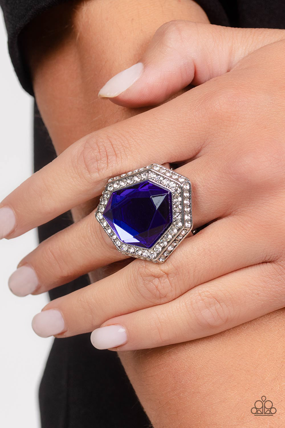 Smoldering Sass Blue Ring - Paparazzi Accessories   An oversized, asymmetrical, royal blue gem smolders inside an asymmetrical, dual frame encrusted with dainty white rhinestones. The resulting sparkle combines into a jaw-dropping, exaggerated centerpiece atop the finger. Features a stretchy band for a flexible fit.  Sold as one individual ring.