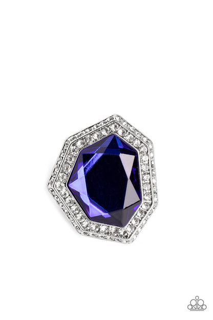 Smoldering Sass Blue Ring - Paparazzi Accessories   An oversized, asymmetrical, royal blue gem smolders inside an asymmetrical, dual frame encrusted with dainty white rhinestones. The resulting sparkle combines into a jaw-dropping, exaggerated centerpiece atop the finger. Features a stretchy band for a flexible fit.  Sold as one individual ring.
