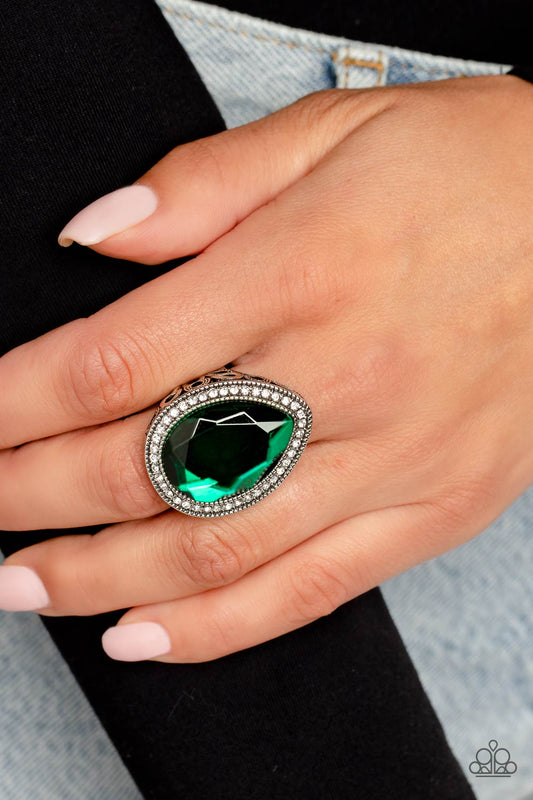 Illuminated Icon Green Ring - Paparazzi Accessories   An oversized green teardrop gem is nestled inside a silver teardrop frame encrusted in dainty white rhinestones. Airy teardrop cutouts decorate each side of the oversized frame, some with subtle texture and others with a high sheen finish. Features a stretchy band for a flexible fit.  Sold as one individual ring.