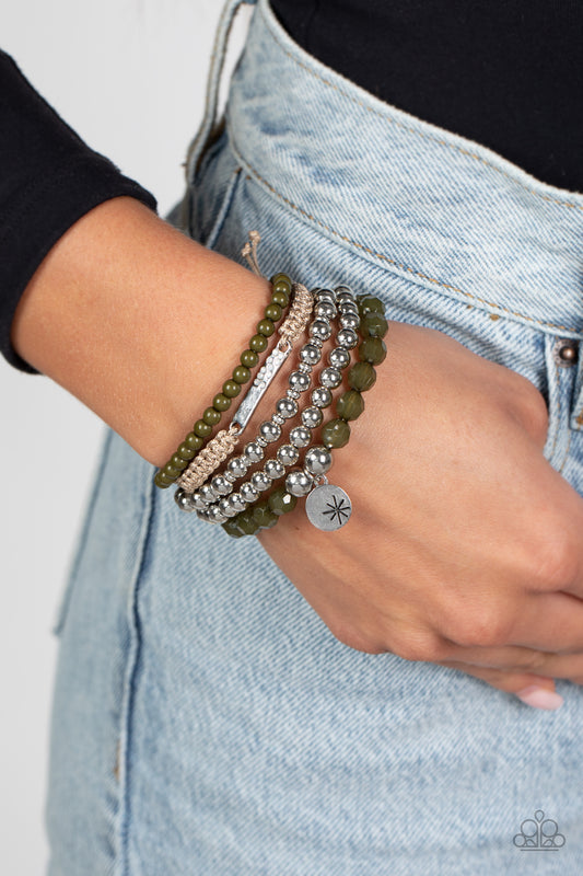 Offshore Outing Green Stretch Bracelet - Paparazzi Accessories  Strands of olive green beads are threaded along elastic stretchy bands to create a stack of bracelets. The varying opacities of each olive green bead adds depth to the design, as a strand of silver beads adds metallic sheen. 