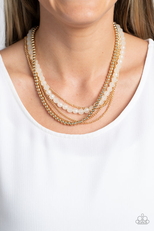 Boardwalk Babe Gold Necklace - Paparazzi Accessories  Shiny gold beads fall together with classic gold chains to create shimmery layers along the collar. A strand of opaque, faceted beads, in the calming shade of ivory, emerges from the backdrop of metallic sheen, adding a subtle pop of color to the invigorating design. Features an adjustable clasp closure.  Sold as one individual necklace. Includes one pair of matching earrings.  P2BA-GDXX-058XX