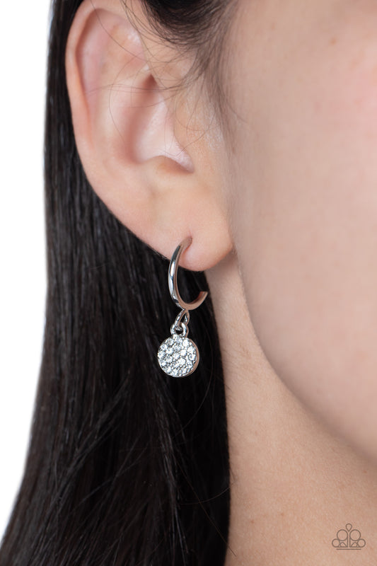 Bodacious Ballroom White Rhinestone Mini Hoop Earring - Paparazzi Accessories  Swinging from a glistening silver hoop, a dainty silver disc, embossed with white rhinestones glimmers, adding a subtle shimmer around the ear. Earring attaches to a standard post fitting. Hoop measures approximately 1/2" in diameter.  Sold as one pair of hoop earrings.  P5HO-WTXX-139XX