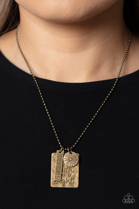 Sunshine Sight Brass Inspirational Necklace - Paparazzi Accessories  Hanging from a brass ball chain, a gritty collection of a rectangular plate dangles next to a disc featuring a sun, and a bar stamped with the Bible reference "2 Corinthians 5:7". The three dangling brass shapes add eye-catching movement to the inspired design. Prominently stamped on the rectangular pendant, the words "Walk by Faith not by Sight" stand out for a faith-filled finish. Includes one pair of matching earrings.