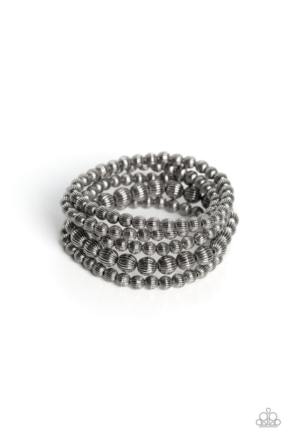 Sonoran Stripes Silver Bracelet - Paparazzi Accessories  Gritty strands of silver beads etched in linear patterns wrap around the wrist on stretchy bands. One strand of the linear silver beads features bigger beads than the rest of the collection for an earthy contrast to the design.  Sold as one set of five bracelets.