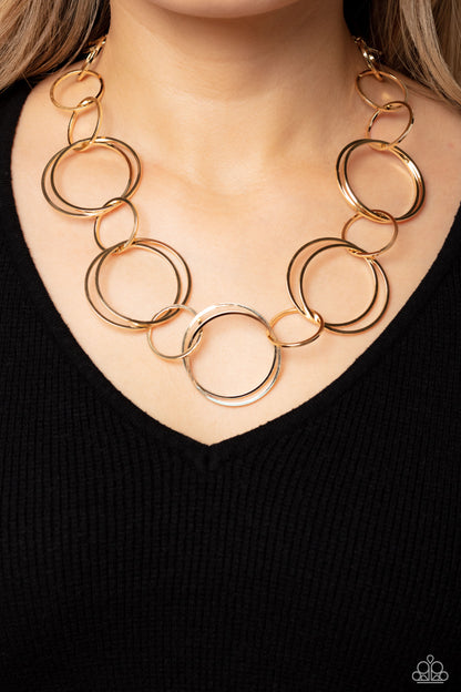 Shimmering Symphony Gold Necklace - Paparazzi Accessories  A shimmering collection of thin gold hoops in varying sizes interlock and coalesce down the neckline for a refined monochromatic statement piece. Features an adjustable clasp closure.  Sold as one individual necklace. Includes one pair of matching earrings.  P2ST-GDXX-143XX