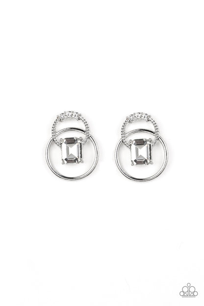 Dangerously Dapper - White Item #E412 Dotted with glassy white rhinestones, a textured silver hoop connects with a smooth silver hoop. An emerald-cut white rhinestone adorns the center of the airy frame for a refined finish. Earring attaches to a standard post fitting. All Paparazzi Accessories are lead free and nickel free!  Sold as one pair of post earrings.