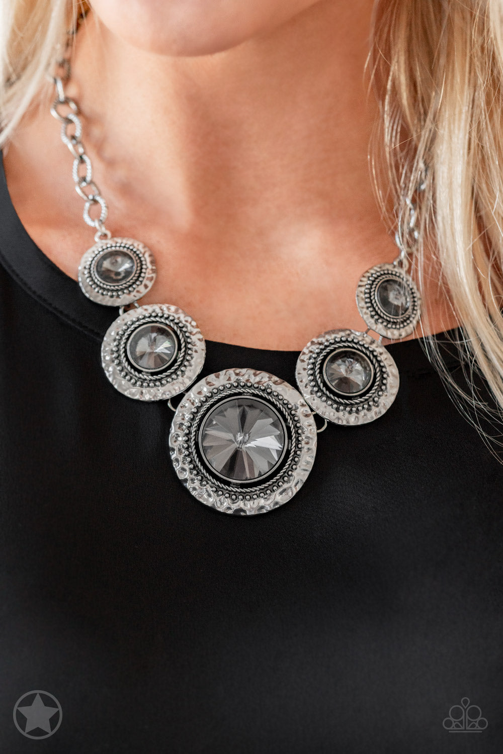 Global Glamour Silver Blockbuster Necklace - Paparazzi Accessories Gradually increasing in size, dramatically oversized smoky gems are pressed into the centers of hammered and silver studded frames. The blinding frames link below the collar for a glamorous, statement-making finish. Features an adjustable clasp closure.   Sold as one individual necklace. Includes one pair of matching earrings.