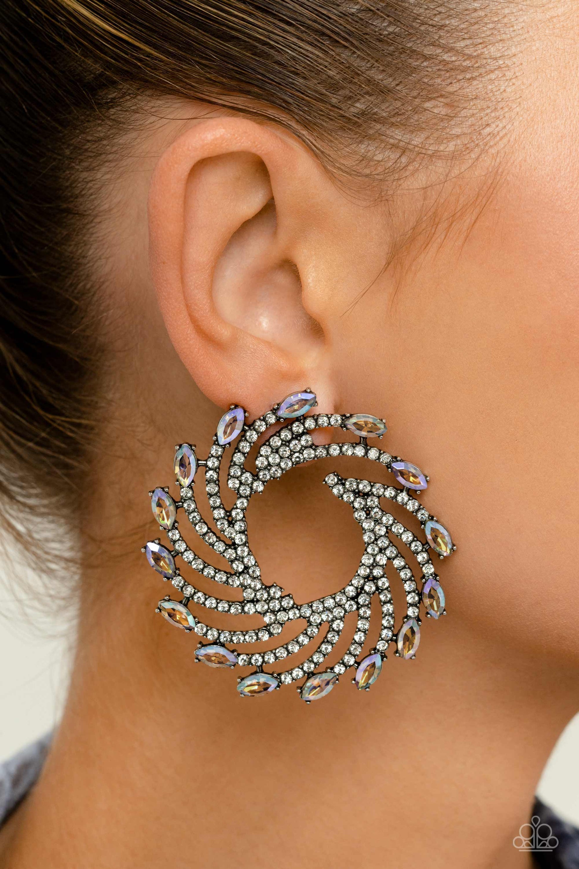 Firework Fanfare Multi Post Earring - Paparazzi Accessories  Shimmery strands of silver spin out from an airy center, creating an exaggerated firework-like display at the ear. An explosion of dainty white rhinestones lines the swirls and curves of the shimmery display leading the eye to the collection of colorfully reflective marquise-cut gems at its ends. Each colorfully reflective marquise-cut gem curls around the ear in a clock-like manner, creating additional eye-catching dimension. P5PO-MTXX-099XX