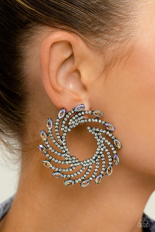 Firework Fanfare Multi Post Earring - Paparazzi Accessories  Shimmery strands of silver spin out from an airy center, creating an exaggerated firework-like display at the ear. An explosion of dainty white rhinestones lines the swirls and curves of the shimmery display leading the eye to the collection of colorfully reflective marquise-cut gems at its ends. Each colorfully reflective marquise-cut gem curls around the ear in a clock-like manner, creating additional eye-catching dimension. P5PO-MTXX-099XX