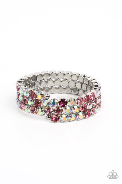 Iridescent Incantation Pink Coil Bracelet - Paparazzi Accessories  Three glistening rows of pink and iridescent gems, pronged in place by silver fittings, curl along a coiled wire, creating a blinding infinity wrap style bracelet around the wrist. Due to its prismatic palette, color may vary.  Sold as one individual bracelet.  P9SE-PKXX-173XX