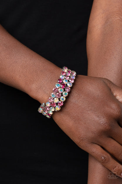 Iridescent Incantation Pink Coil Bracelet - Paparazzi Accessories  Three glistening rows of pink and iridescent gems, pronged in place by silver fittings, curl along a coiled wire, creating a blinding infinity wrap style bracelet around the wrist. Due to its prismatic palette, color may vary.  Sold as one individual bracelet.  P9SE-PKXX-173XX