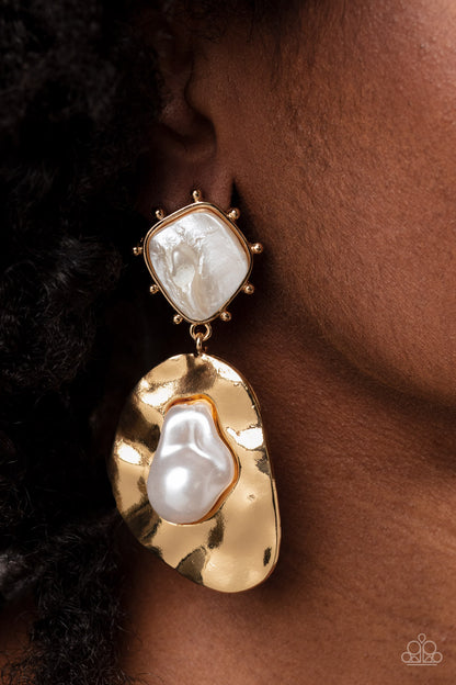 Rippling Rhapsody Gold Post Earring - Paparazzi Accessories   An oversized hammered, asymmetrical gold disc dangles from a more dainty, asymmetrical gold frame, accented with raised gold studs around its edges. Pressed in the center of the studded display, an abstract, white shell with a pearlized finish shines while a baroque pearl gleams for a refined finish inside the oversized display. Earring attaches to a standard post fitting.  Sold as one pair of post earrings.