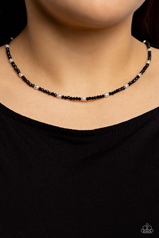 Beaded Blitz Black Seed Bead Necklace - Paparazzi Accessories  A dainty row of faceted black crystal-like seed beads delicately links around the neck, resulting in a radiant glimmer. Dainty white, oval pearls infused along the neckline create additional refinement and charm to the design. Features an adjustable clasp closure.  Sold as one individual necklace. Includes one pair of matching earrings.  P2DA-BKXX-179XX