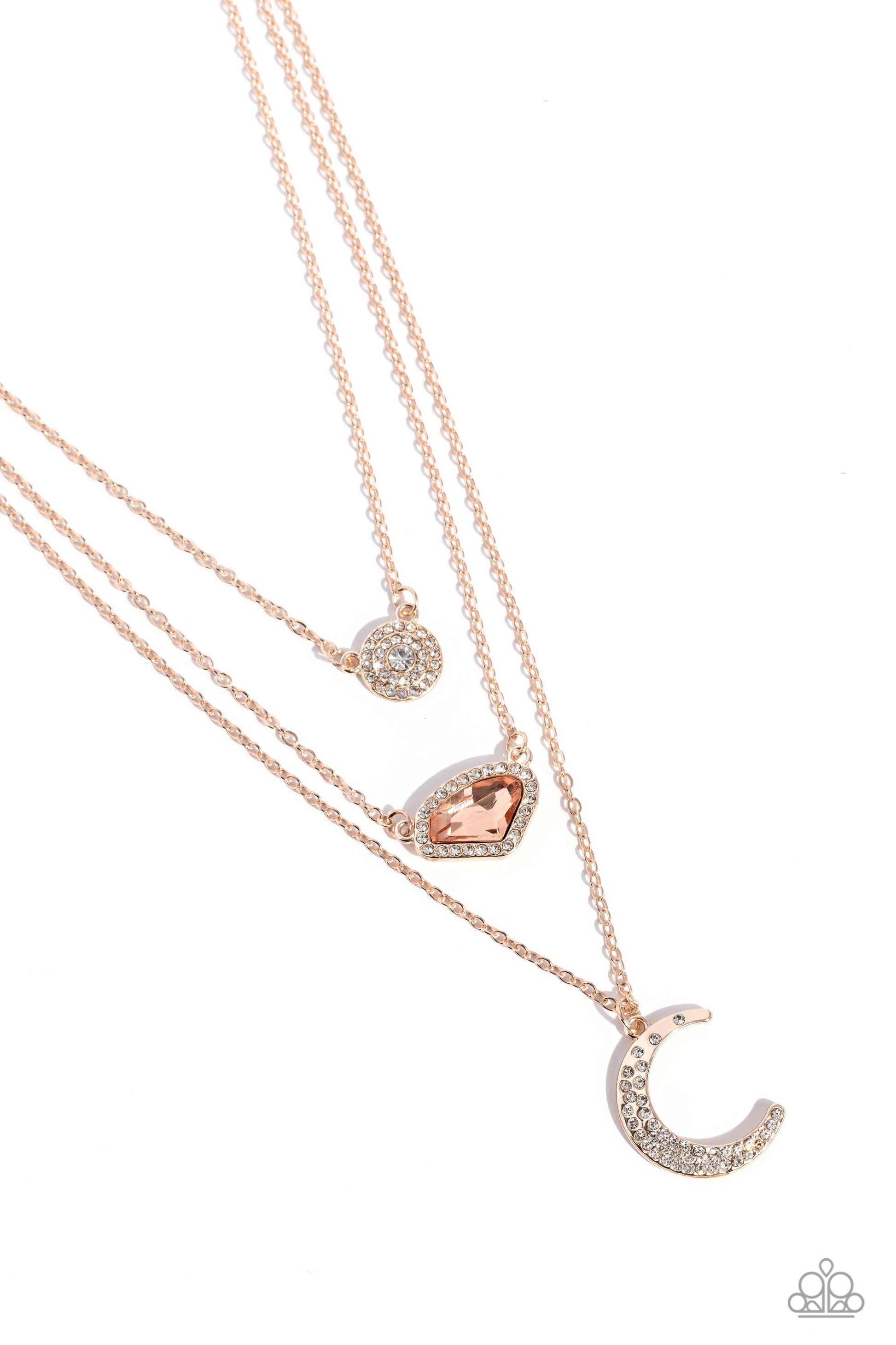 Lunar Lineup Rose Gold Necklace - Paparazzi Accessories  Three shimmery rose gold chains, infused with three stellar pendants, layer across the chest in a celestial display. A dainty, white rhinestone-encrusted, rose gold pendant with a white center swings from the uppermost chain, followed by an asymmetrical, jagged, peach gem encased in a border of dainty white rhinestones, and a rose gold crescent moon charm with dainty white rhinestones, creating a starry shimmer.