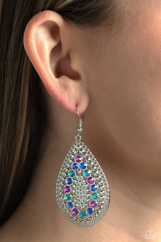 Spirited Socialite Multi Earring - Paparazzi Accessories  Set against an airy, dot motif backdrop, faceted purple and various shades of blue rhinestones curve into a teardrop shape atop an oversized silver teardrop lure, creating a dazzling pop of color near the ear. Earring attaches to a standard fishhook fitting.  Sold as one pair of earrings.  P5RE-MTXX-126XX
