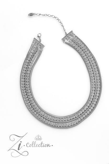 Tenacious White 2023 Zi Collection Necklace - Paparazzi Accessories  Flat, silver snake chains alternate with rows of explosive sparkle, layering into a dynamic lineup of grit and glitz. The meticulous placement and uniform sizing of the glittery, white rhinestones are contrasted by the slithering movement of the snake chains, as the strands drape into a dramatic finish. Features an adjustable clasp closure.