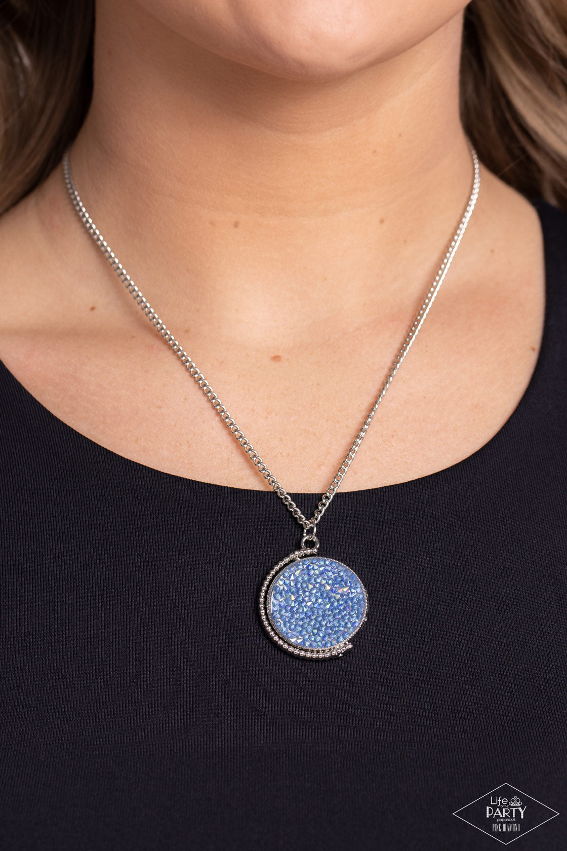 My Moon and Stars Multi Necklace - Paparazzi Accessories  A smoldering collision of blue iridescent and pink iridescent rhinestones are encrusted across the front and back of a textured silver disc below the collar. Threaded along a dainty rod, the glittery pendant effortlessly spins on its axis inside a silver studded half-circle frame. Features an adjustable clasp closure. Due to its prismatic palette, color may vary.