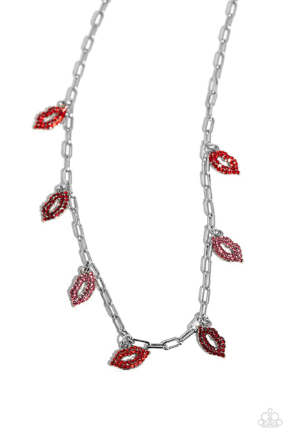 KISS the Mark Red Necklace - Paparazzi Accessories  Set along a silver paperclip chain, a pouty collection of lip charms, each embossed in red, dark red, and pink rhinestones alternates below the collar for a love-struck fashion. Features an adjustable clasp closure.  Sold as one individual necklace. Includes one pair of matching earrings.  P2WH-RDXX-336XX