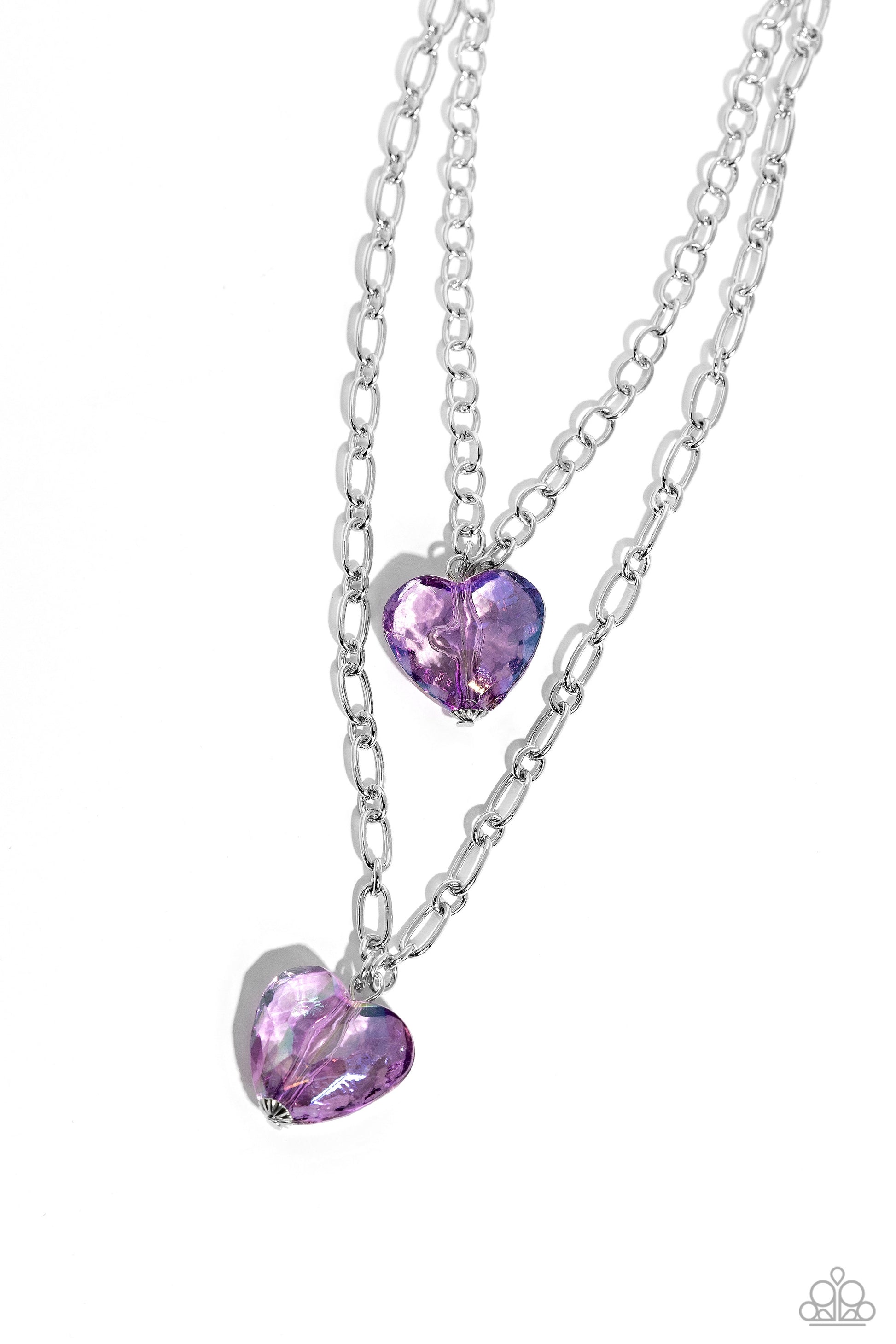 Layered Love Purple Heart Necklace - Paparazzi Accessories  Featuring a subtle iridescent shimmer, two glassy purple gem hearts are delicately suspended above one another on a paperclip and silver oval link chain for a whimsical double-stacked display. Features an adjustable clasp closure.  Sold as one individual necklace. Includes one pair of matching earrings.  SKU: P2WH-PRXX-446XX